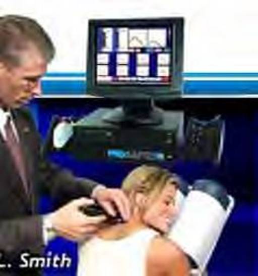 Dr. Smith uses a computer to analyze and gently adjust the spine.