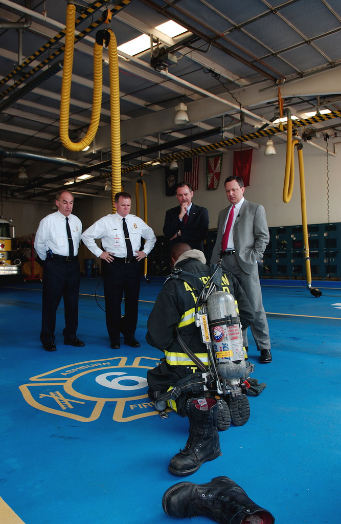 Under Secretary Michael D. Brown watches as Firefighter/EMT Todd Bevans...