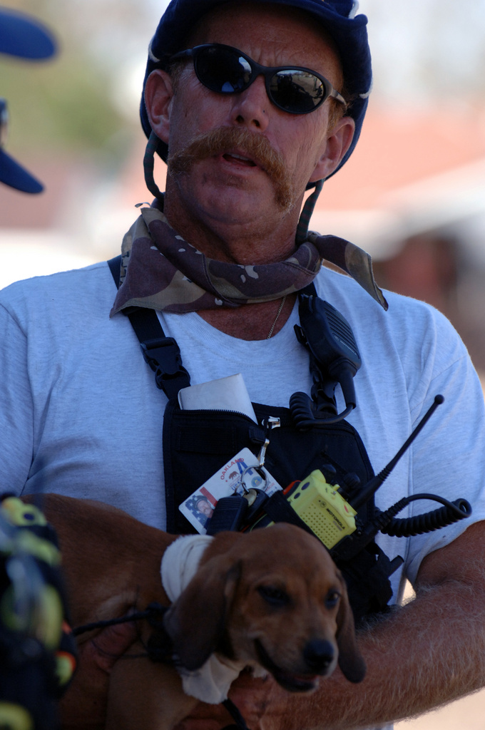 New Orleans: A FEMA Urban Search and Rescue member pets a stranded dog...