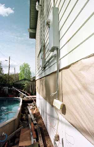 FEMA Hazard Mitigation. Raising the power box along the side of this home...