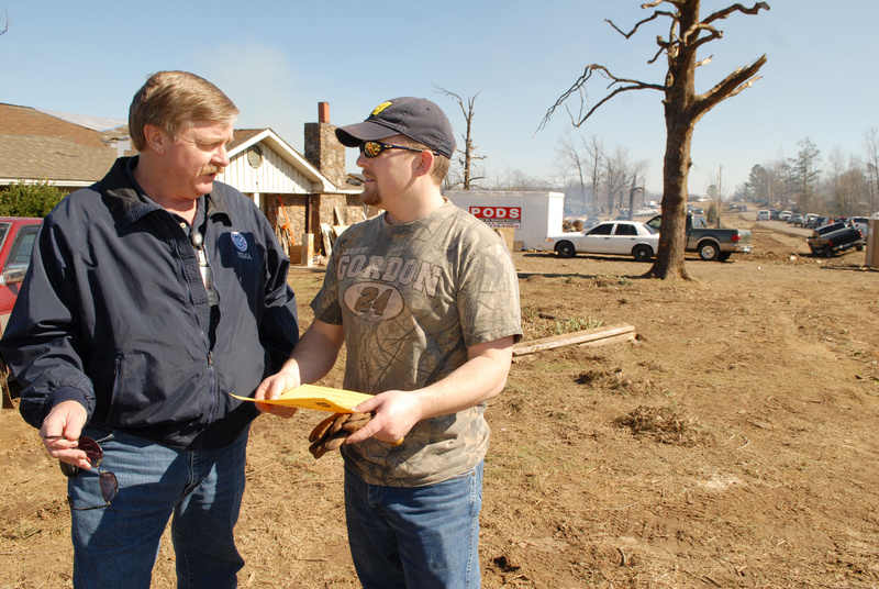 Atkins: A FEMA public information officer gives information to a resident...