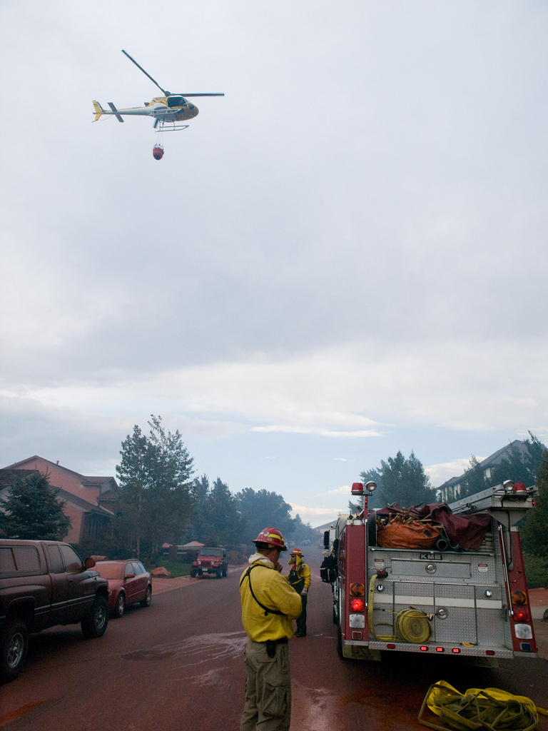 Lakewood: A Helicopter drops buckets of water to assist fire fighters...