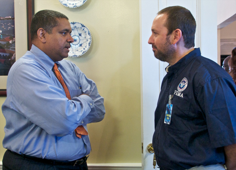 IMAT USVI Team leader, Jose Rodriguez talks with USVI Governor, John P....