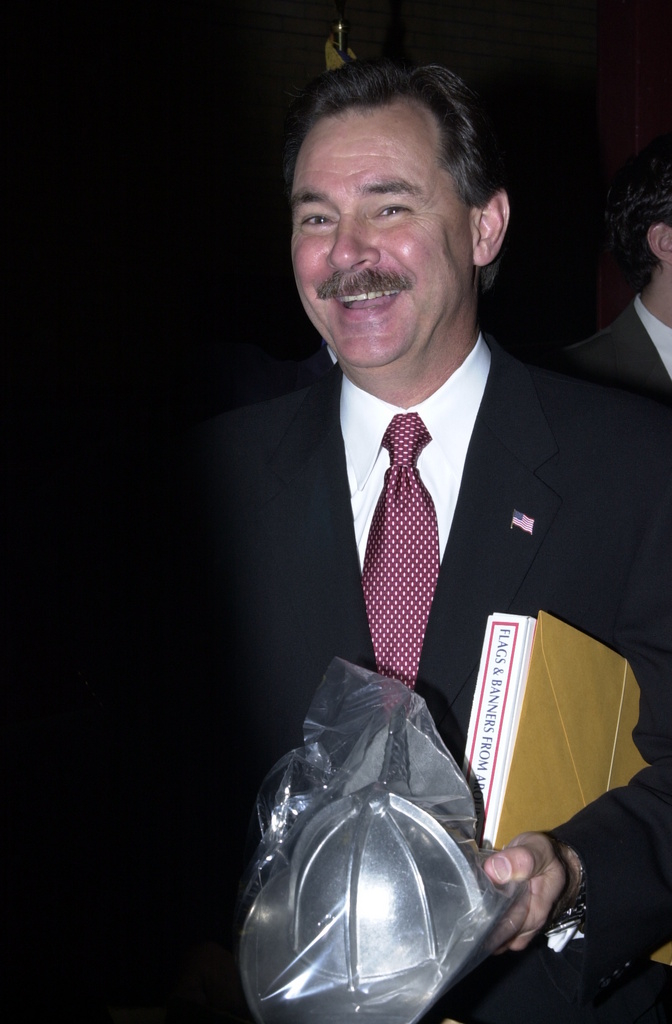 R. David Paulison recieves a gift from Representative Curt Weldon after...