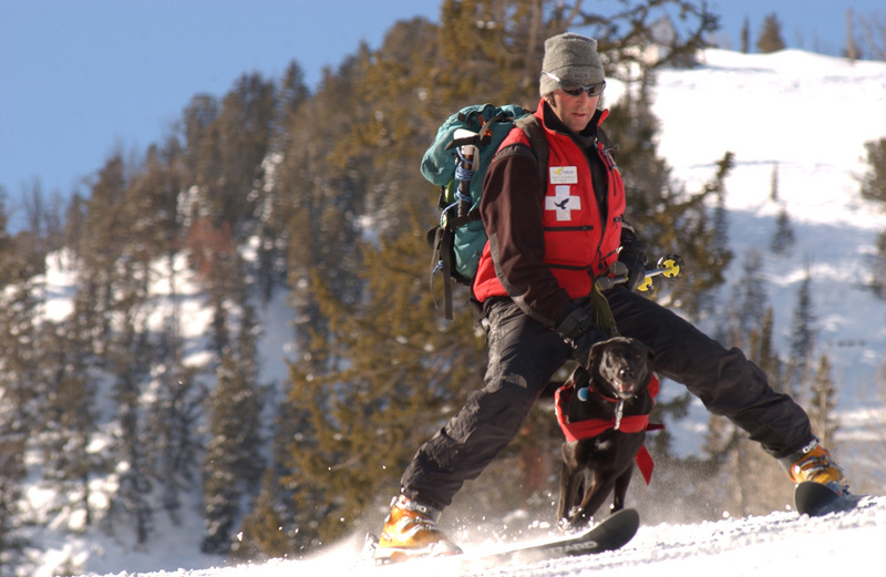 Solitude ski patrolman Keith Sternfels and his black lab Chaco ski/run...