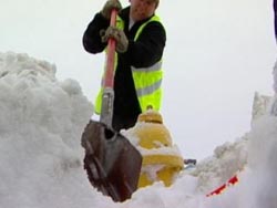 Parma: A CERT member digs out a fire hydrant after a snowstorm.