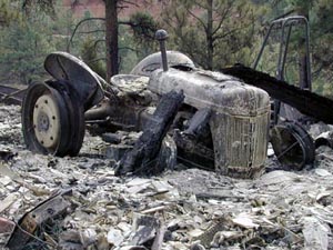 Loveland: Tractor burned and melted by the fire. Photo by Andrea Booher/FEMA...