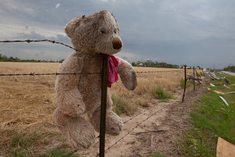 El Reno: A teddy bear stuck on a fence and personal belongings piled high...