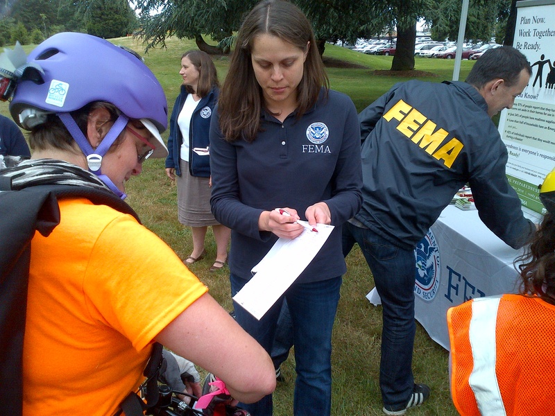 Seattle: A FEMA employee shares emergency preparedness information with...