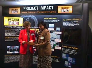 Elkins: Expo Chair, Judy Guye talks with Priscilla Scruggs, Project Impact...